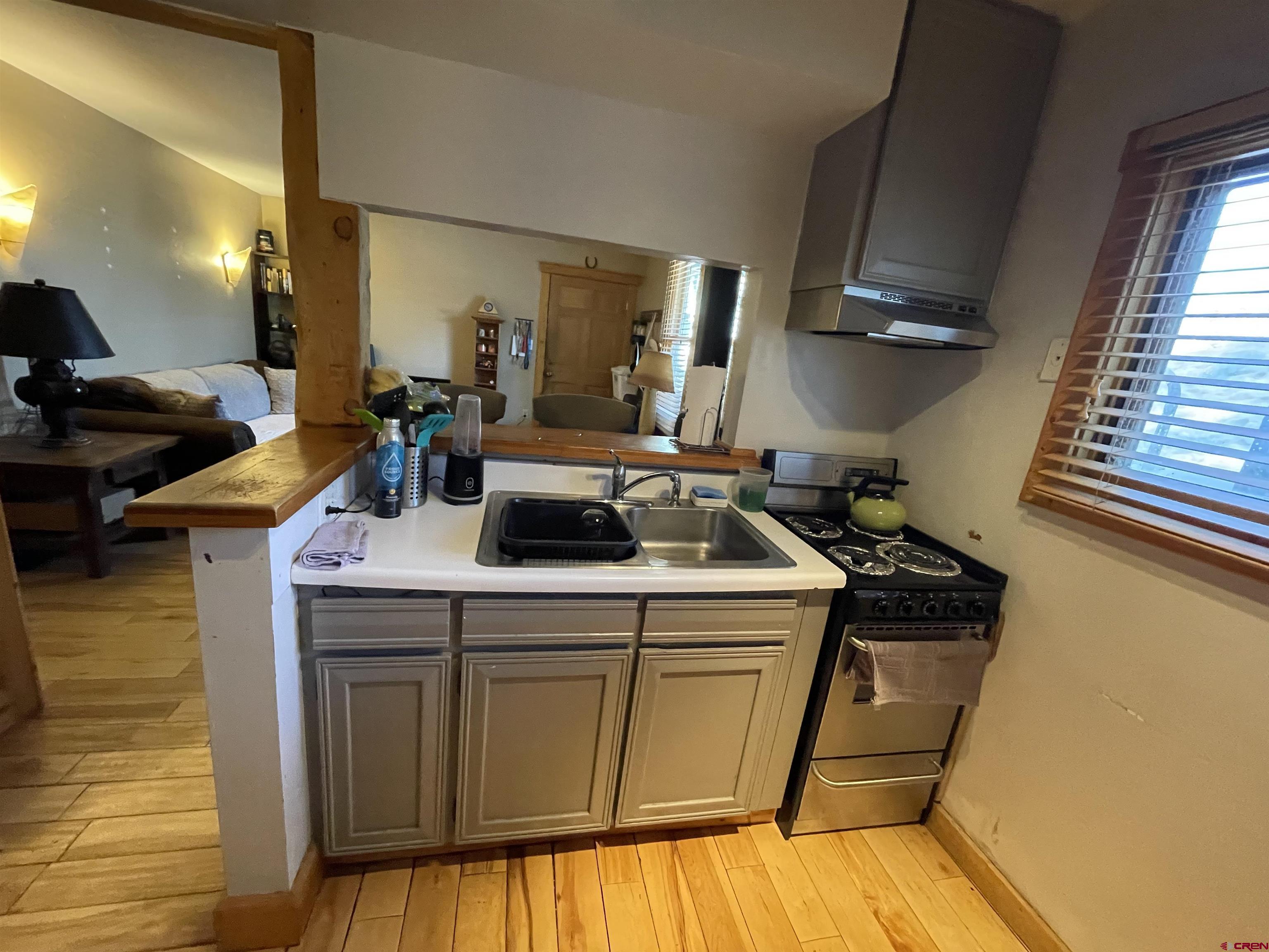 28 Whiterock Avenue, Unit 2 Crested Butte, CO 81224 - Photo 8 of 31 a kitchen with a sink a stove cabinets and a wooden floor