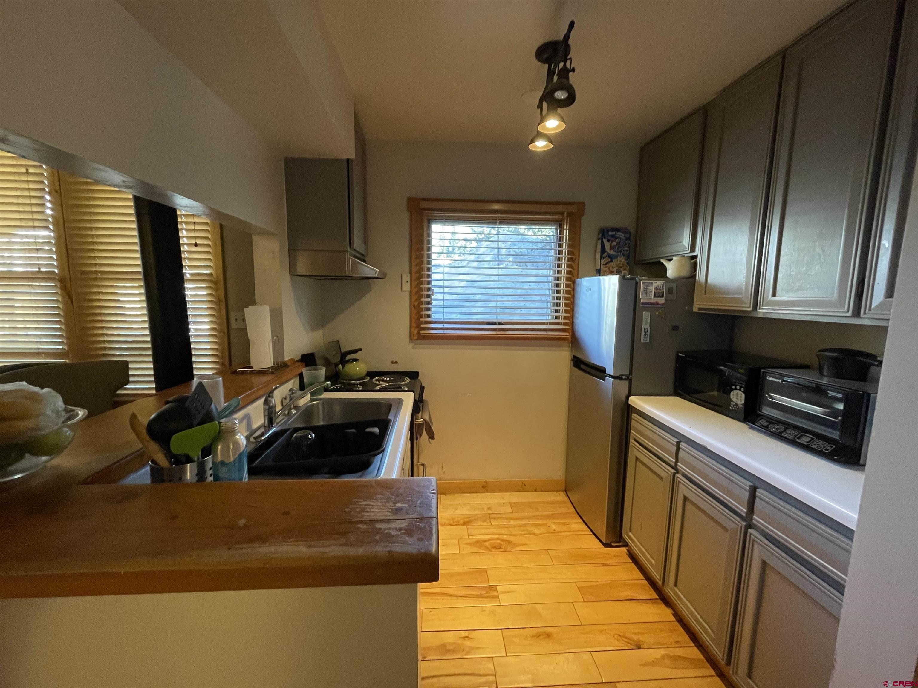 28 Whiterock Avenue, Unit 2 Crested Butte, CO 81224 - Photo 10 of 31 a kitchen with stainless steel appliances granite countertop a sink stove and refrigerator