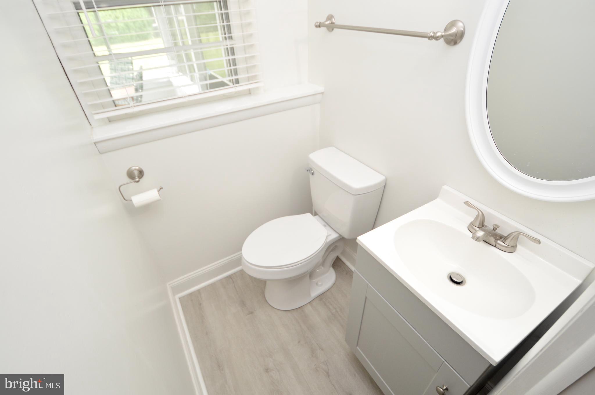 119 Ashbrook Road Cherry Hill, NJ 08034 - Photo 13 of 16 a white toilet sitting next to a bathroom sink