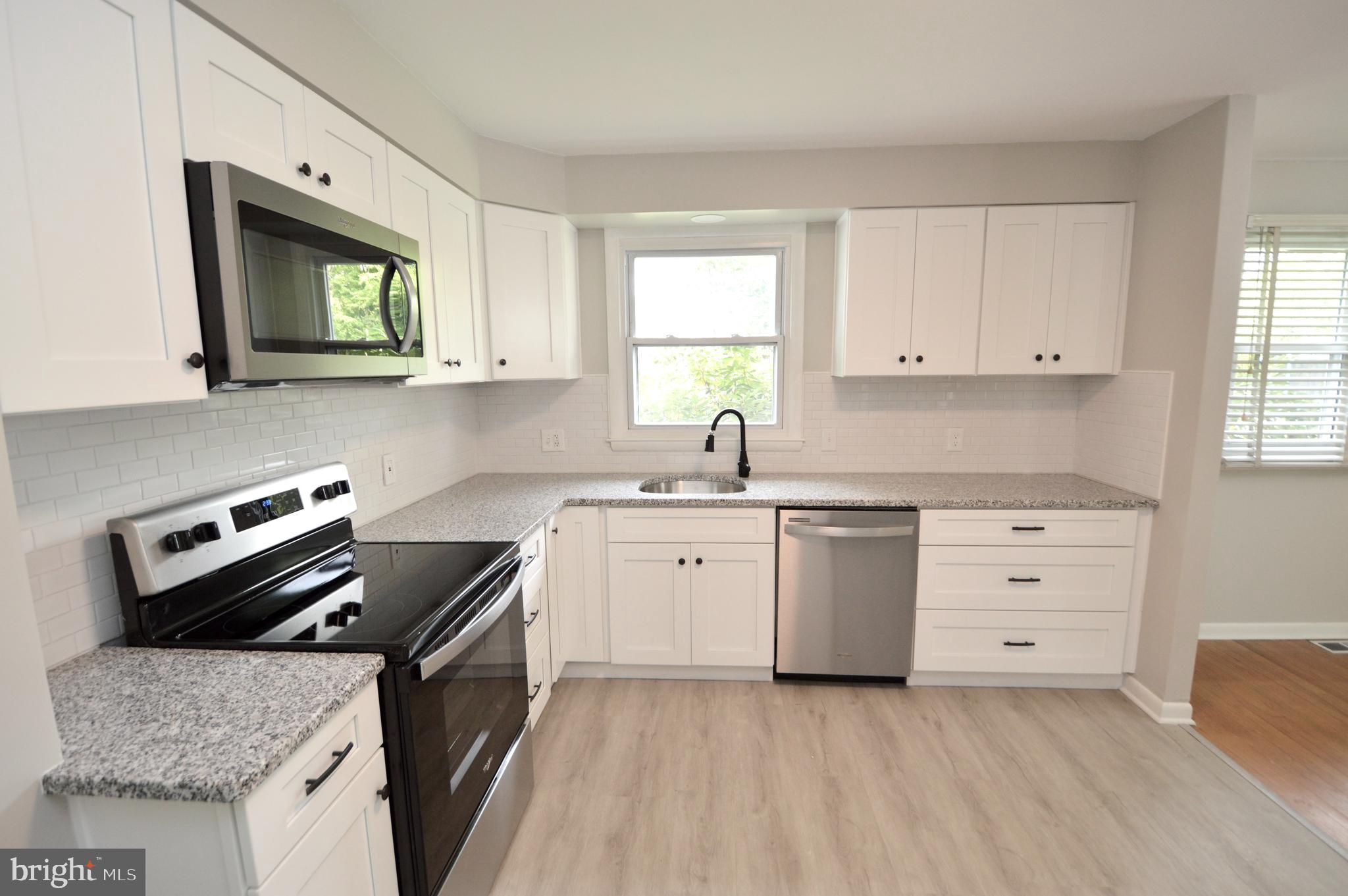 119 Ashbrook Road Cherry Hill, NJ 08034 - Photo 5 of 16 a kitchen with granite countertop a sink stove and cabinets