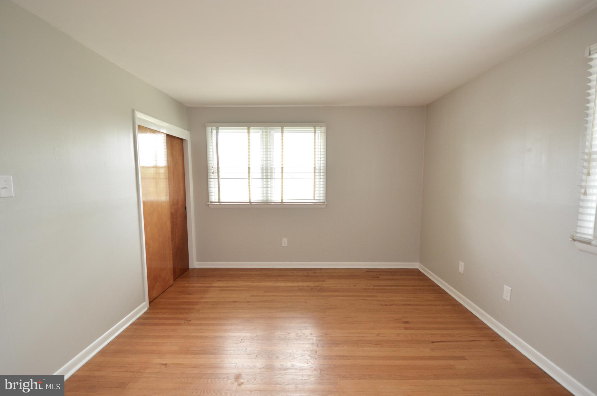 119 Ashbrook Road Cherry Hill, NJ 08034 - Photo 10 of 16 wooden floor in an empty room with a window