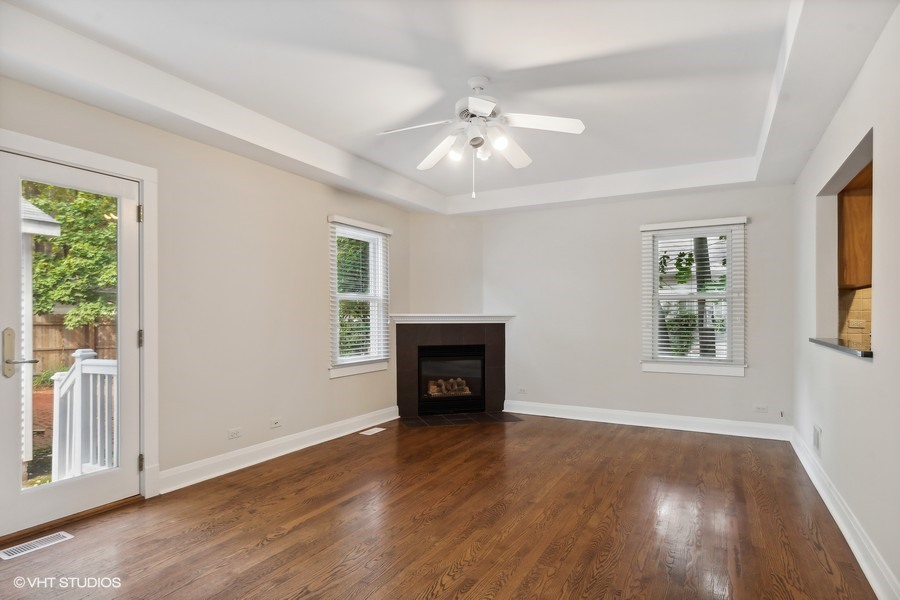 1282 Edgewood Road Lake Forest, IL 60045 - Photo 11 of 27 an empty room with wooden floor fireplace and windows