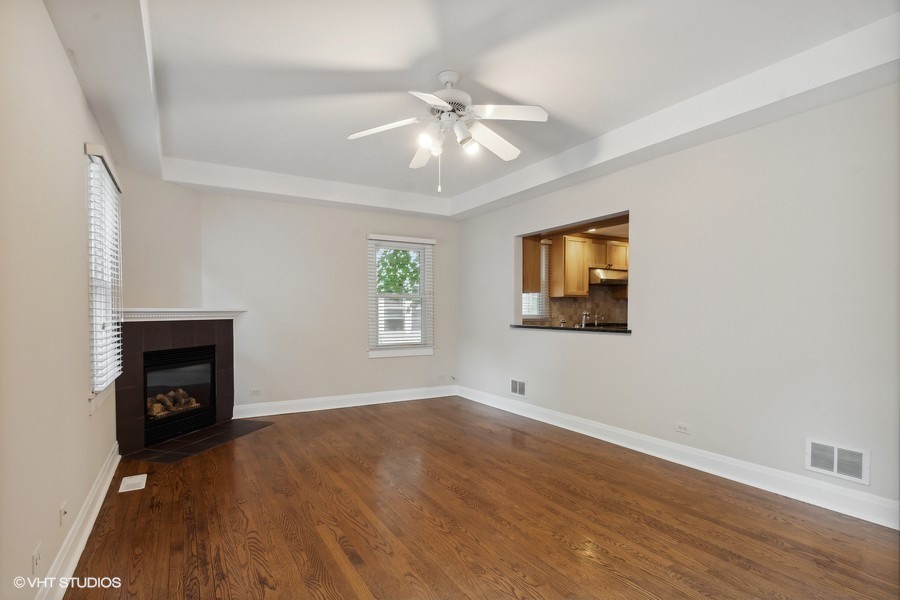 1282 Edgewood Road Lake Forest, IL 60045 - Photo 12 of 27 wooden floor fireplace and windows in an empty room