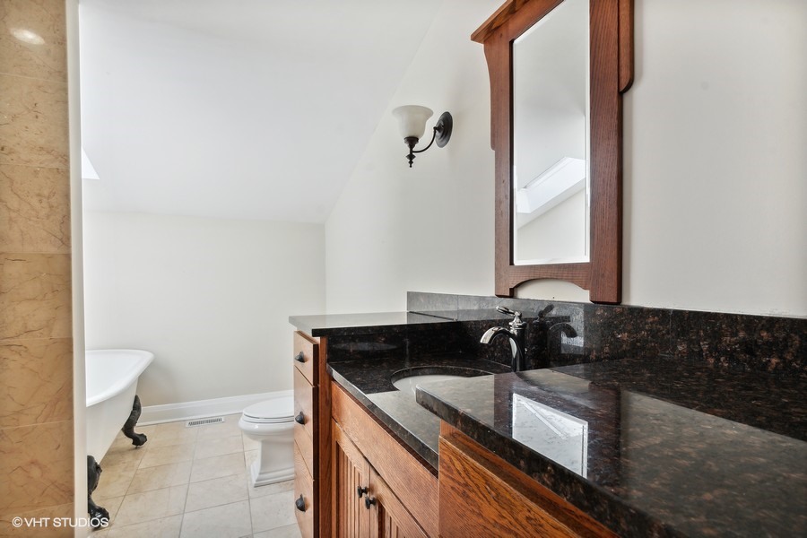 1282 Edgewood Road Lake Forest, IL 60045 - Photo 18 of 27 a bathroom with a granite countertop sink and a toilet
