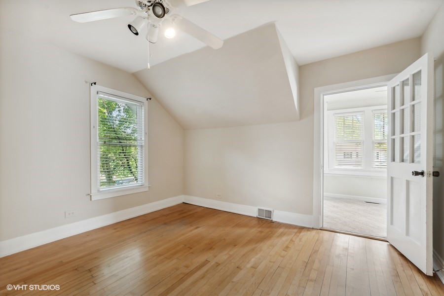 1282 Edgewood Road Lake Forest, IL 60045 - Photo 19 of 27 an empty room with wooden floor chandelier fan and windows