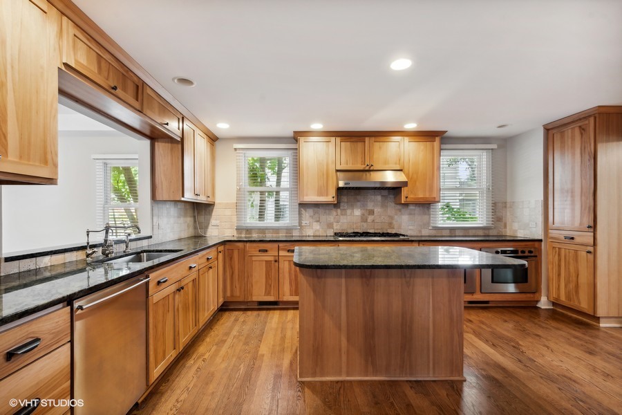 1282 Edgewood Road Lake Forest, IL 60045 - Photo 3 of 27 a kitchen with stainless steel appliances granite countertop wooden cabinets a sink and dishwasher a oven with wooden floors