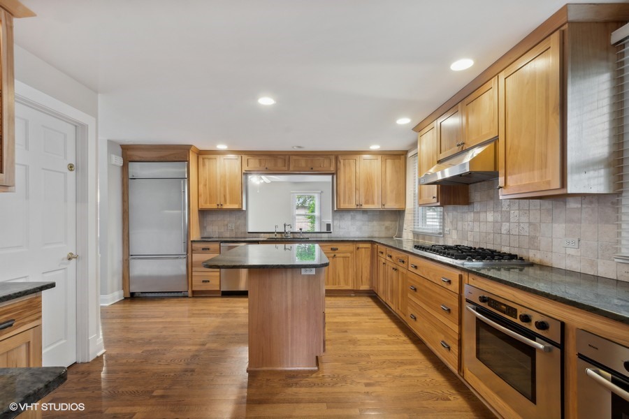 1282 Edgewood Road Lake Forest, IL 60045 - Photo 4 of 27 a kitchen with stainless steel appliances granite countertop a sink a stove and a refrigerator