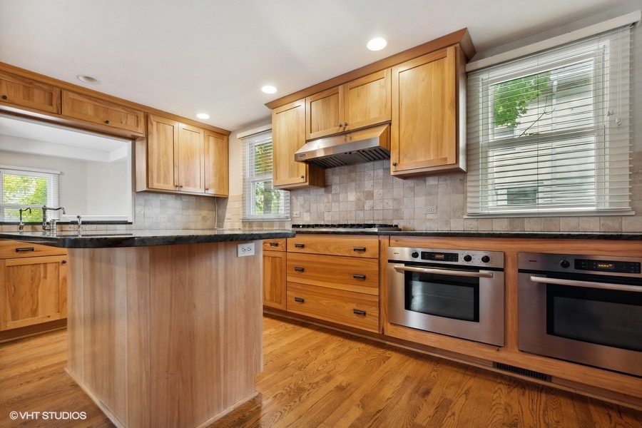 1282 Edgewood Road Lake Forest, IL 60045 - Photo 5 of 27 a kitchen with stainless steel appliances granite countertop a stove a sink and a microwave
