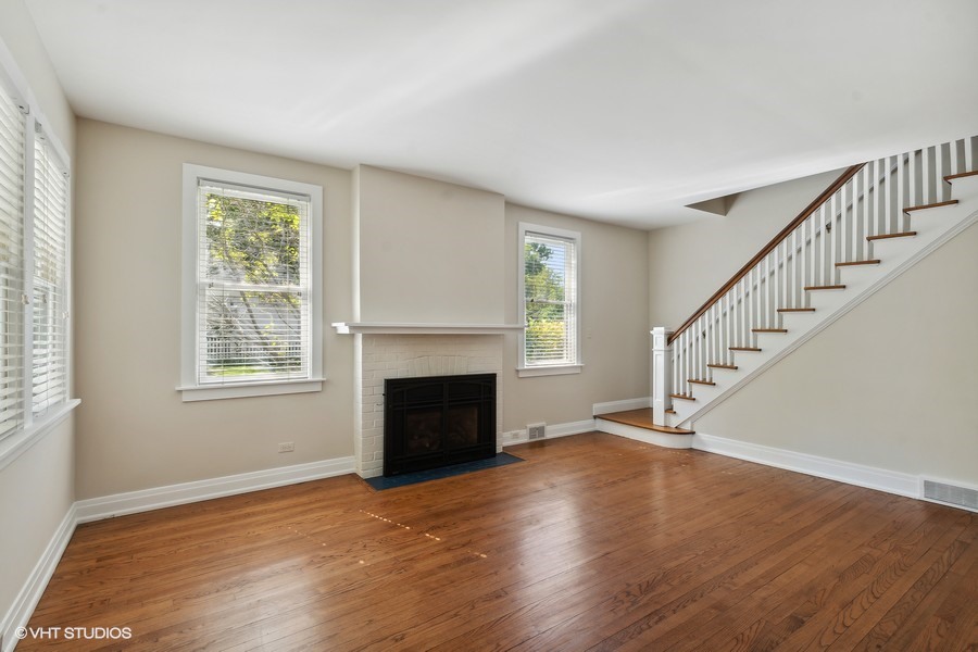 1282 Edgewood Road Lake Forest, IL 60045 - Photo 8 of 27 a view of an empty room with wooden floor fireplace and a window