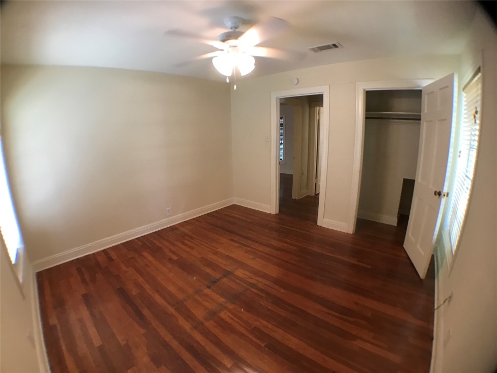 2509 Enfield Road, Unit C Austin, TX 78703 - Photo 11 of 14 Unfurnished bedroom with dark wood-style flooring, a closet, and ceiling fan