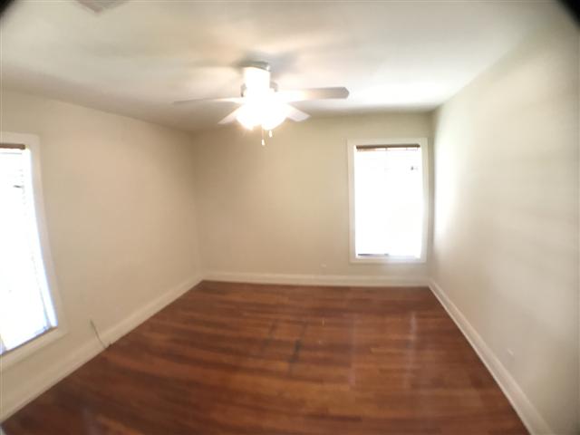 2509 Enfield Road, Unit C Austin, TX 78703 - Photo 8 of 14 Unfurnished room with dark wood finished floors and ceiling fan