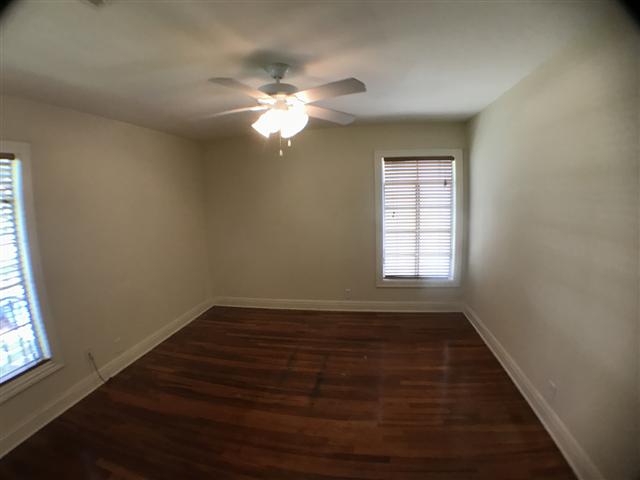 2509 Enfield Road, Unit C Austin, TX 78703 - Photo 9 of 14 Empty room featuring dark wood-type flooring and a ceiling fan
