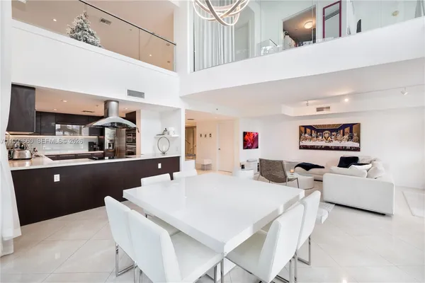 a large white kitchen with a large window