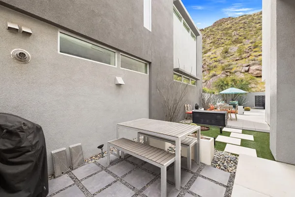 a view of an house with backyard space and balcony