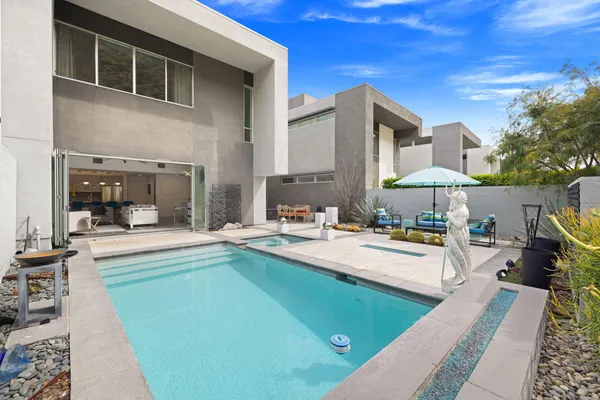 a view of swimming pool with outdoor seating and plants