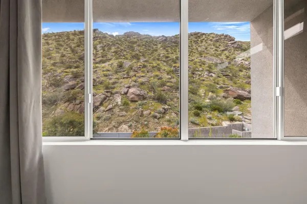 a kitchen with stainless steel appliances kitchen island a table chairs in it and wooden floors