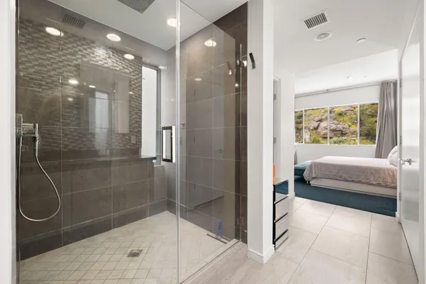 a bedroom with two beds and a large window
