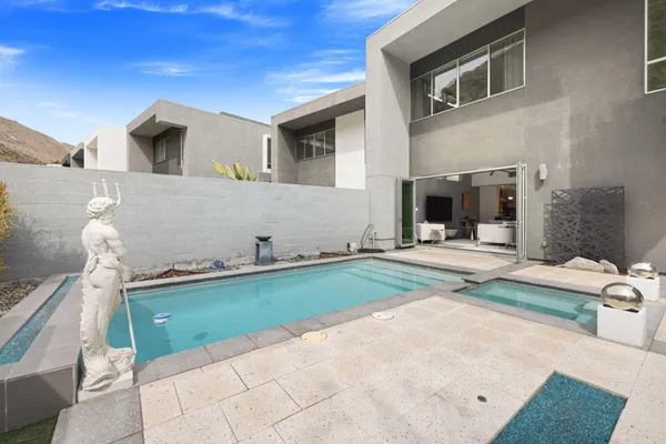a bedroom with furniture and a flat screen tv
