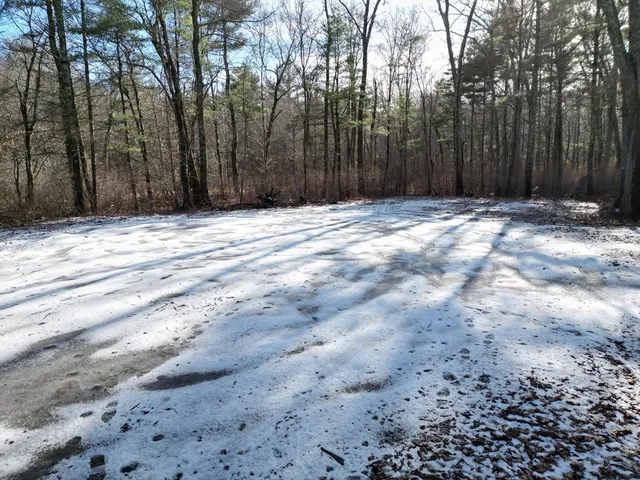 a view of wooden fence and trees