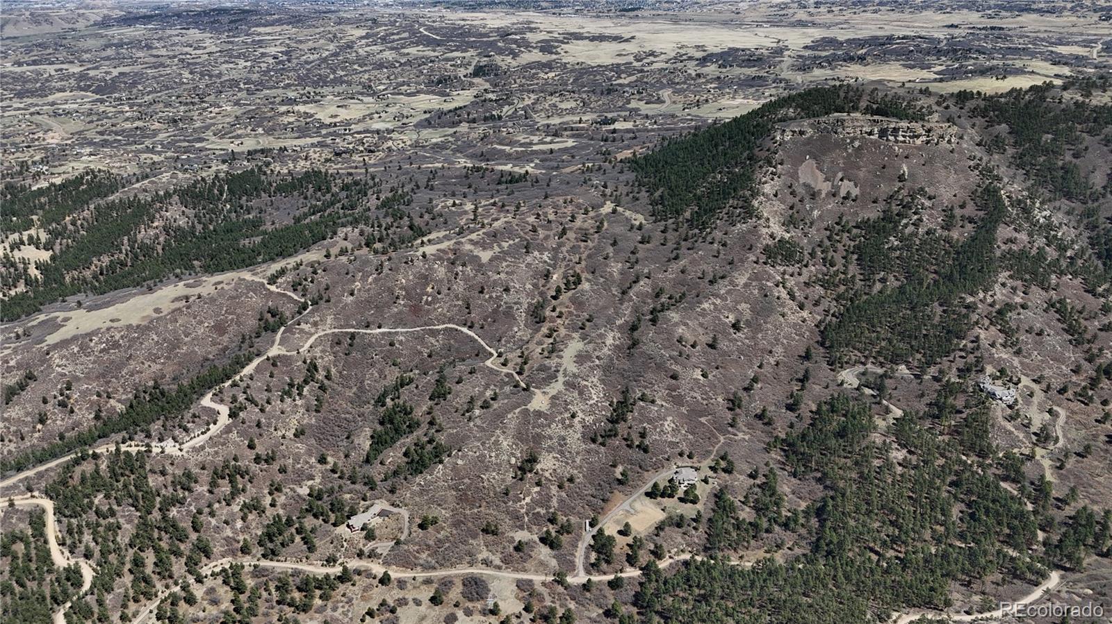 1 South Perry Park Road Sedalia, CO 80135 - Photo 16 of 25 a view of a dry yard with trees and bushes