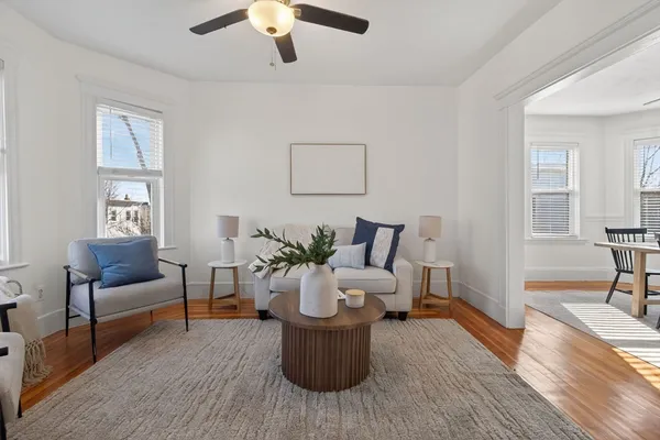 a living room with furniture and a wooden floor