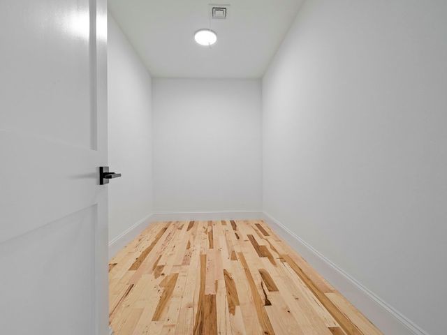 a view of a room with wooden floor