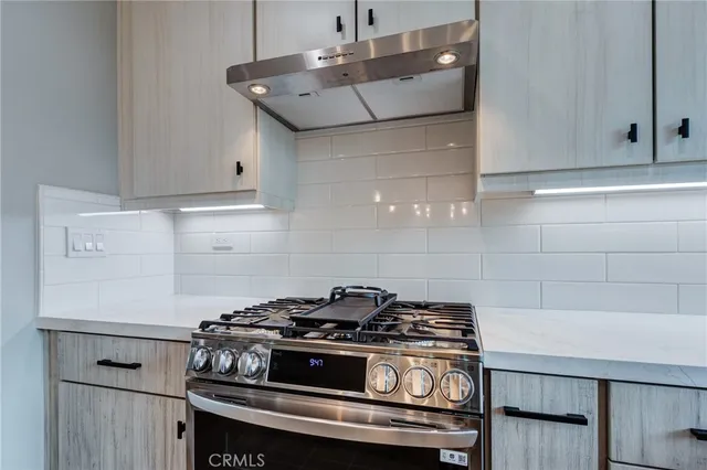 a kitchen with cabinets and a stove top oven