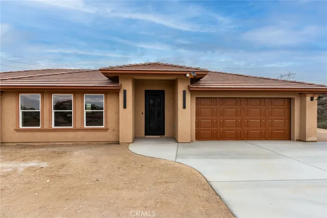 front view of a brick house with a garage