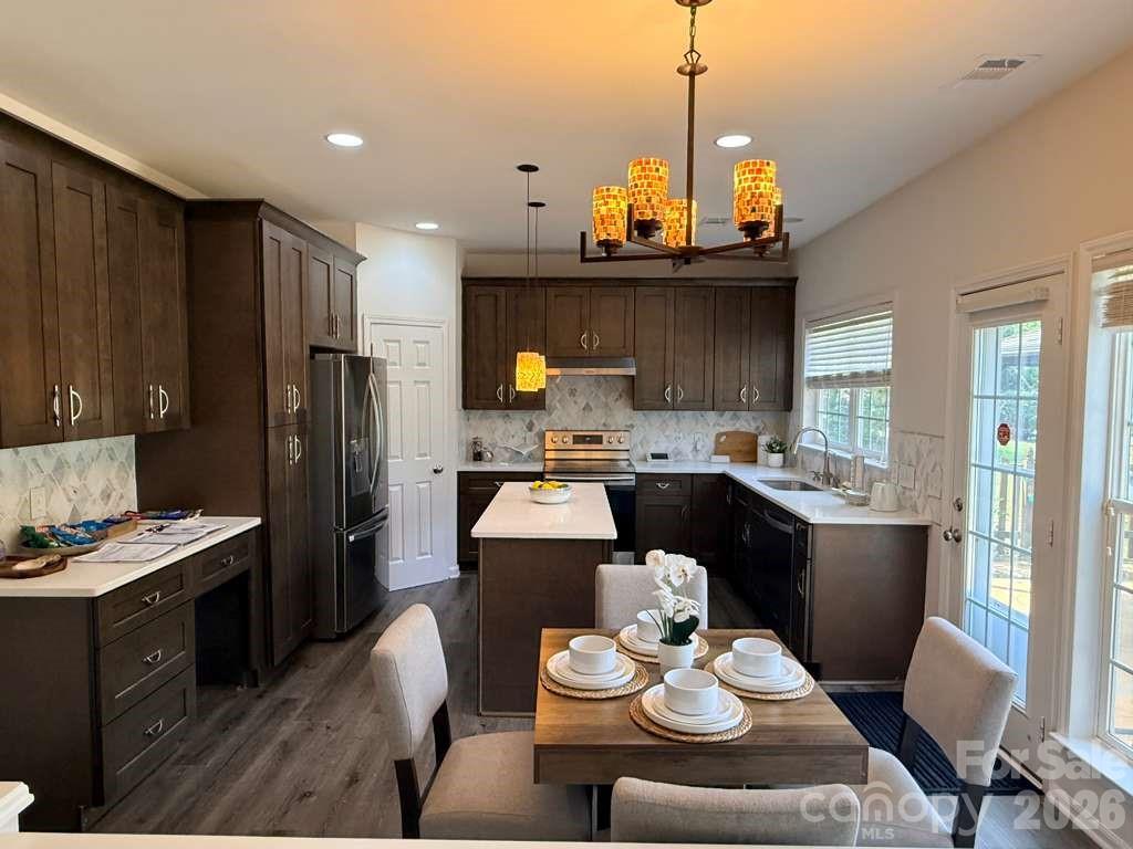3530 Arborhill Road Charlotte, NC 28270 - Photo 8 of 45 a kitchen with a refrigerator and a stove