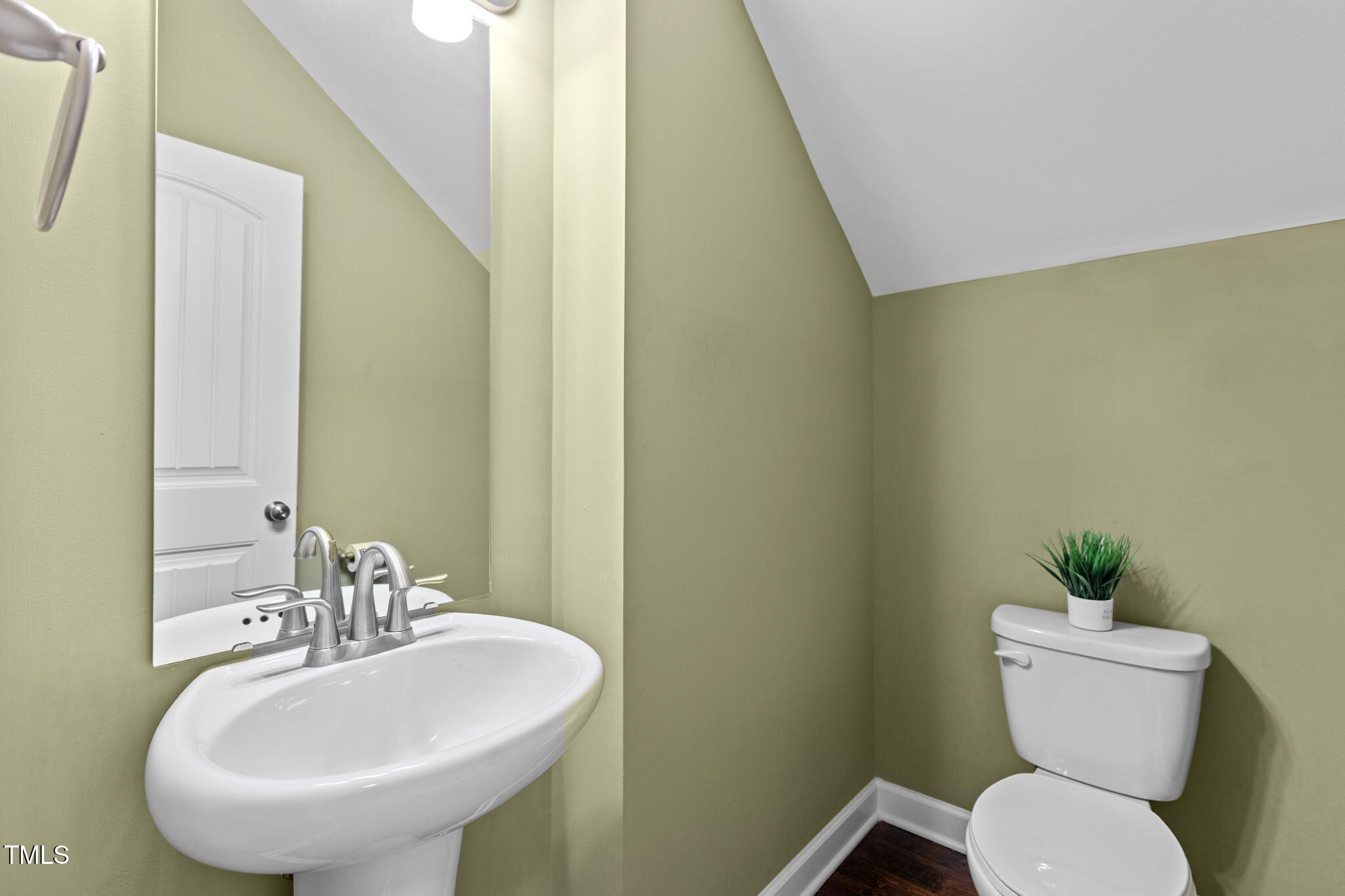 3412 South Beaver Lane Raleigh, NC 27604 - Photo 12 of 30 a bathroom with a toilet sink and mirror