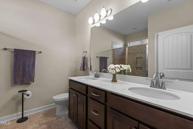 a bathroom with a double vanity sink and a mirror