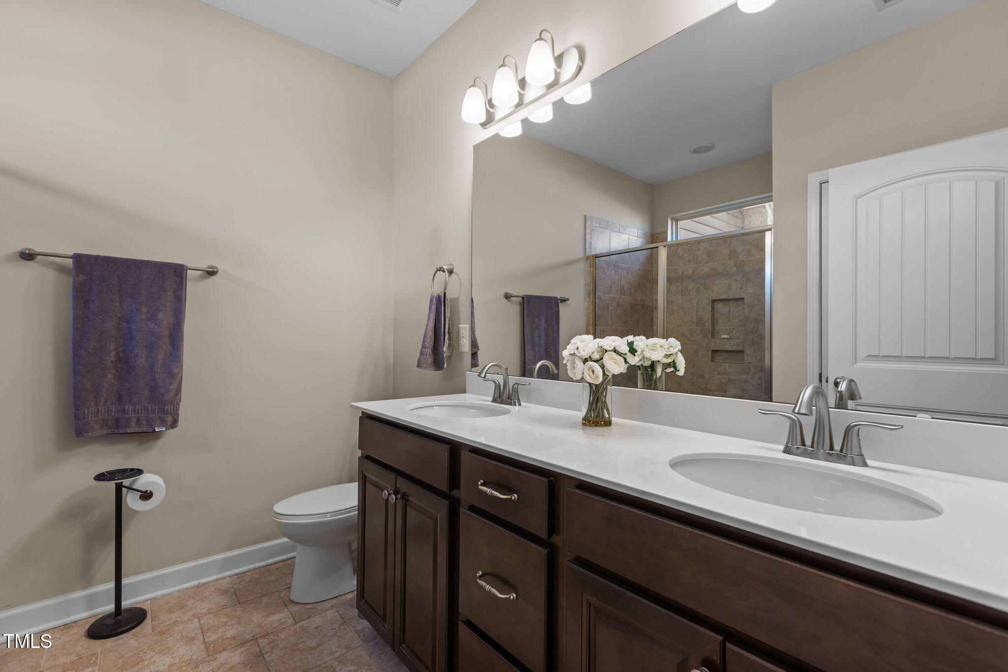 3412 South Beaver Lane Raleigh, NC 27604 - Photo 14 of 30 a bathroom with a double vanity sink and a mirror