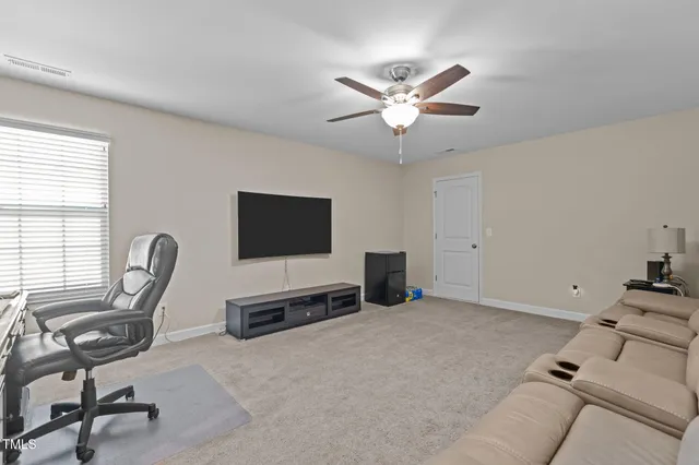 a view of a livingroom with workspace and a window