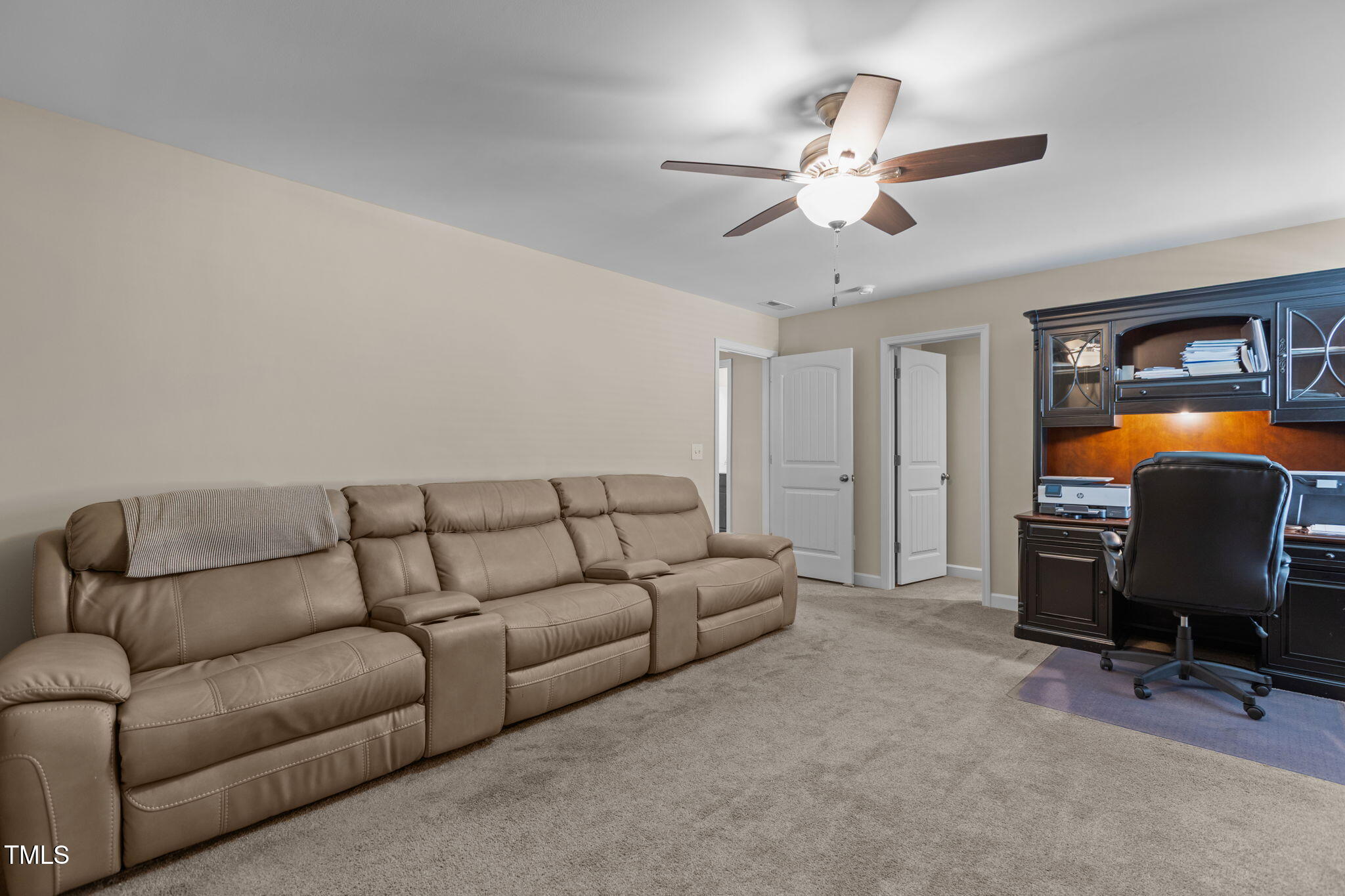 3412 South Beaver Lane Raleigh, NC 27604 - Photo 23 of 30 a living room with furniture a ceiling fan and a rug