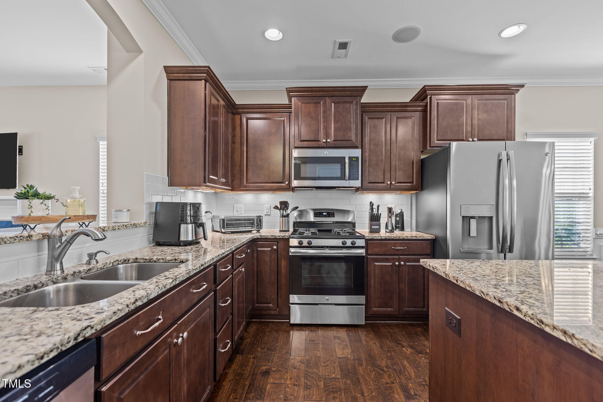3412 South Beaver Lane Raleigh, NC 27604 - Photo 3 of 30 a kitchen with stainless steel appliances granite countertop a sink stove microwave and refrigerator