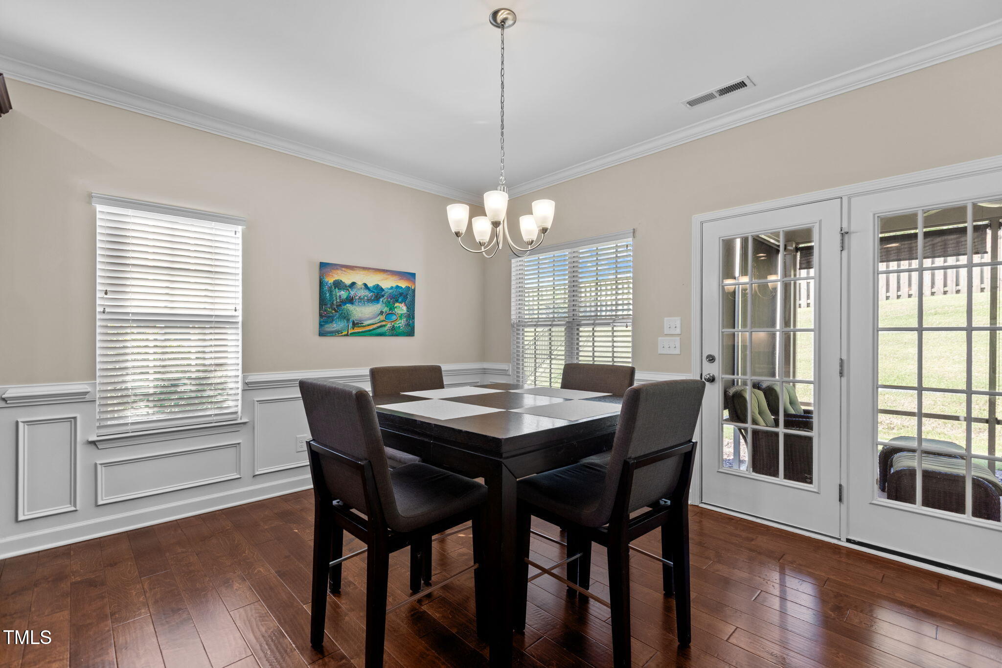3412 South Beaver Lane Raleigh, NC 27604 - Photo 4 of 30 a dining room with furniture a chandelier and wooden floor