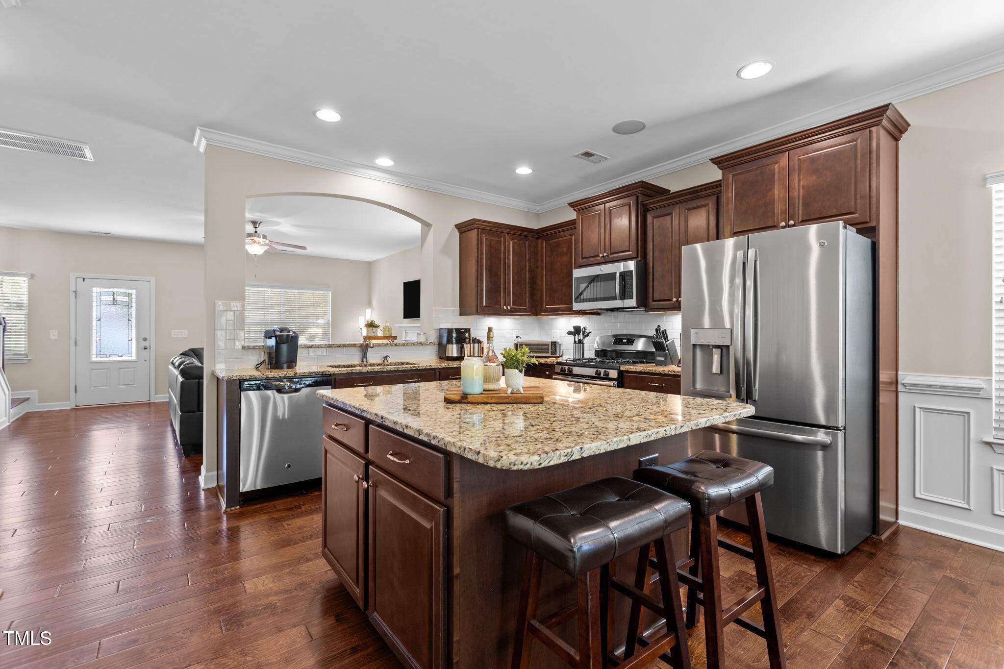 3412 South Beaver Lane Raleigh, NC 27604 - Photo 5 of 30 a kitchen with stainless steel appliances granite countertop a refrigerator a stove a sink a dining table and chairs