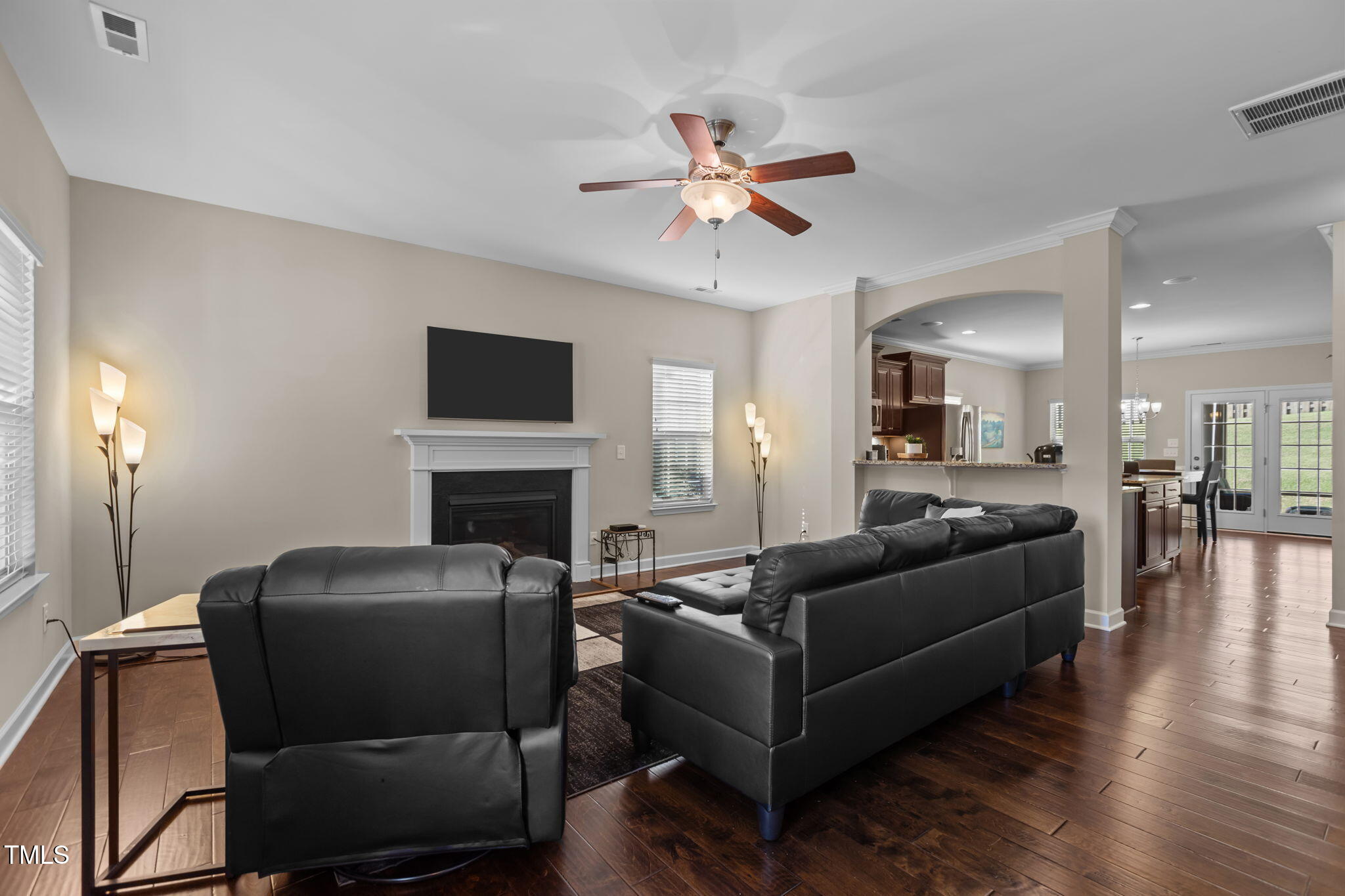 3412 South Beaver Lane Raleigh, NC 27604 - Photo 7 of 30 a living room with furniture a fireplace and a flat screen tv