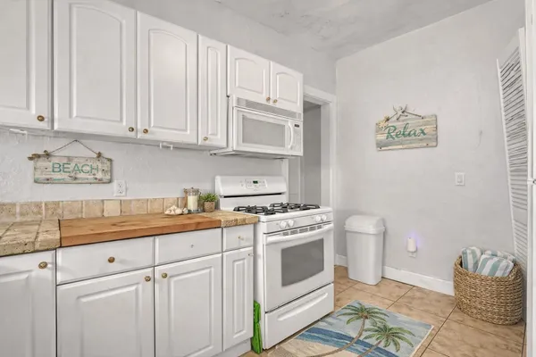 a kitchen with stainless steel appliances granite countertop a sink and a stove