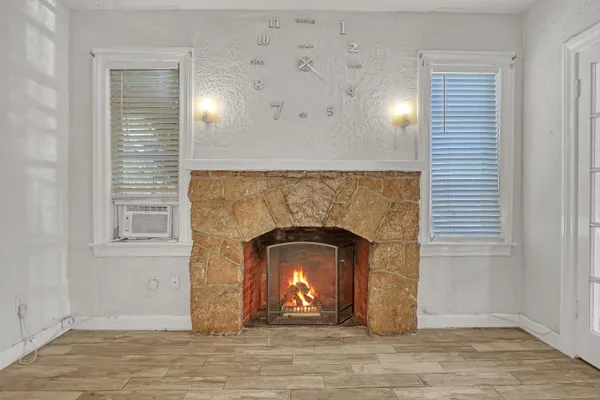a view of an empty room and fire place