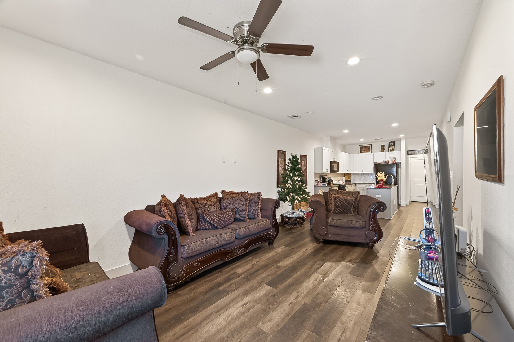 1035 Junell Street Houston, TX 77088 - Photo 5 of 14 a living room with furniture kitchen view and a flat screen tv