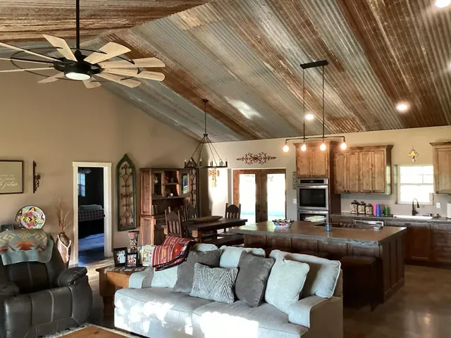 a living room with furniture and a chandelier