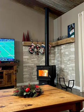 a bedroom with a bed and a fireplace