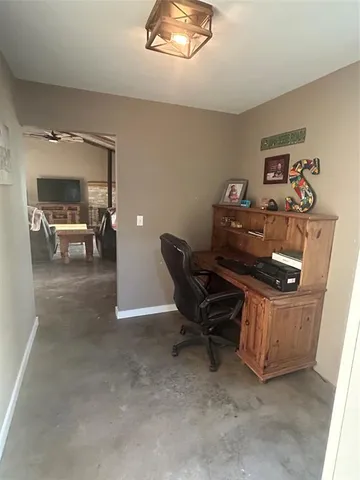 a living room with furniture and a dining table