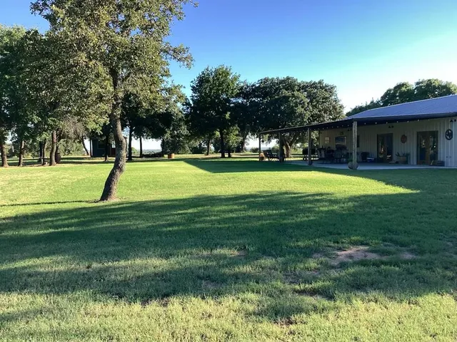 a view of a house with a big yard