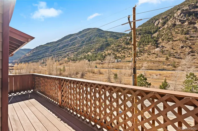 a view of a balcony with wooden fence