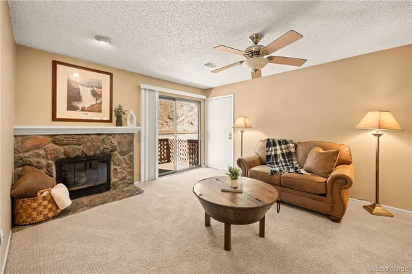 a living room with furniture and a fireplace