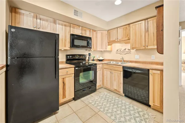 a kitchen with a stove sink and refrigerator