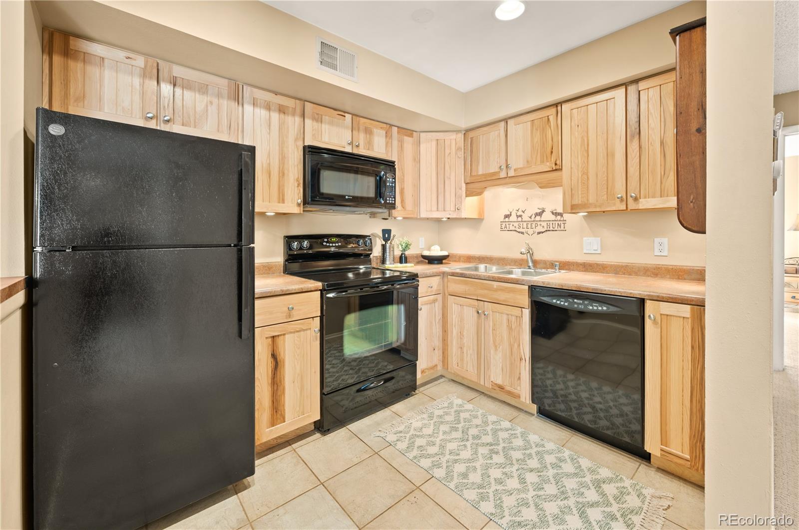 1890 Argentine Street, Unit 303 Georgetown, CO 80444 - Photo 5 of 22 a kitchen with a stove sink and refrigerator