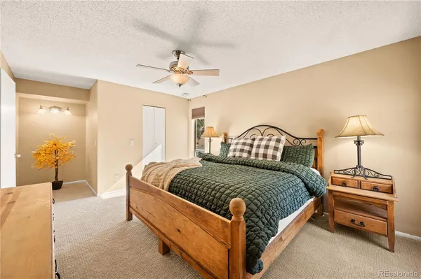 a bedroom with a bed lamp and a dresser